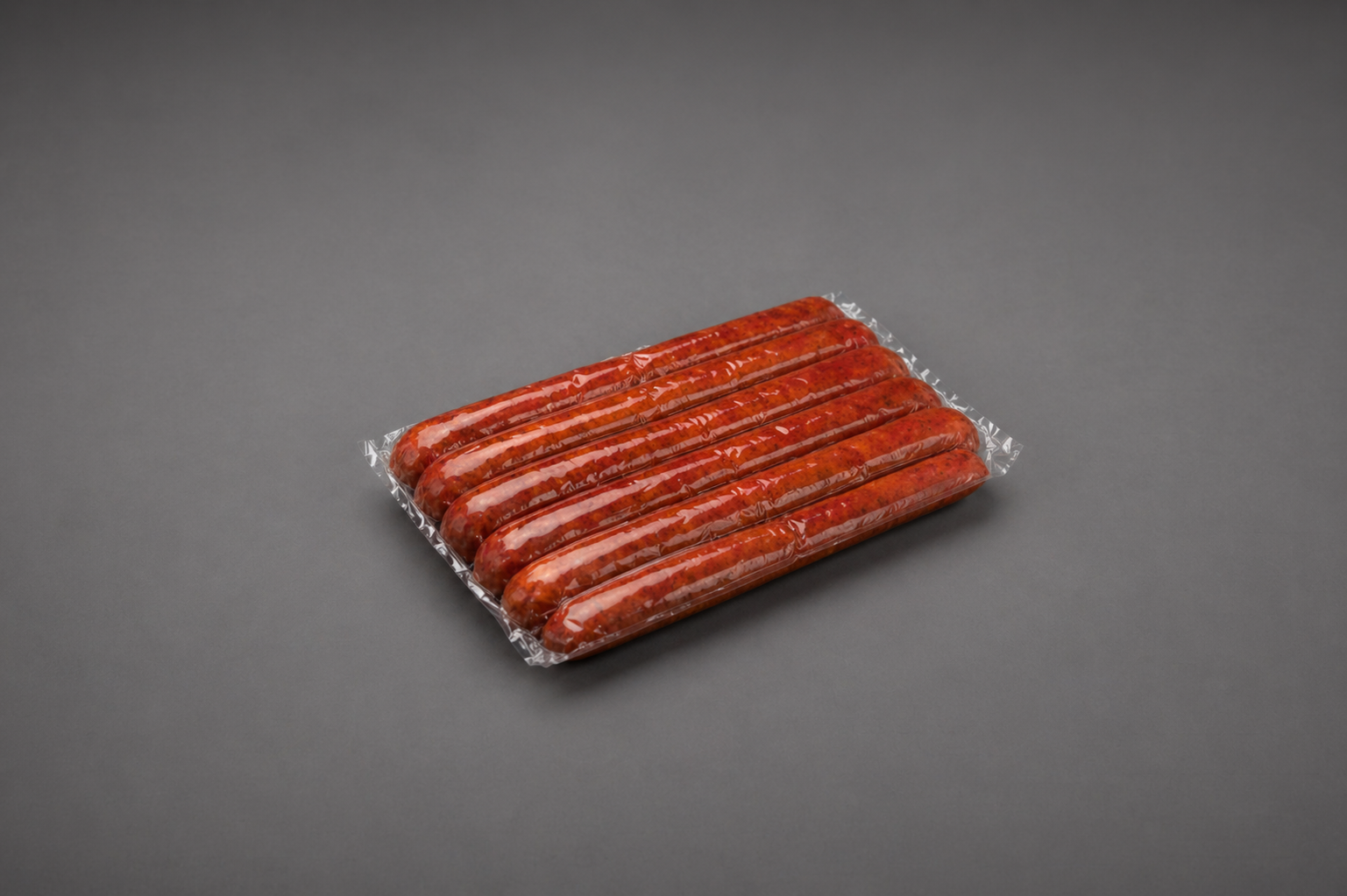 Vacuum-sealed sausage pack on a neutral background